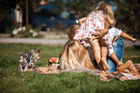Mother with kids have fun on the grassの写真素材