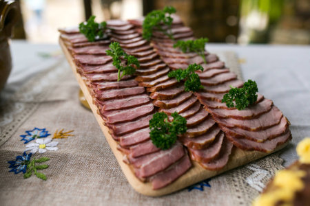 meat cutting on a wooden tray with a sprig of dillの写真素材