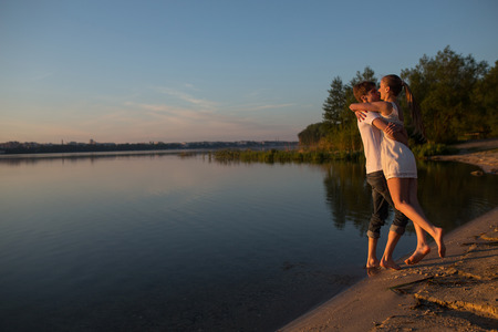 Couple in sunrise on the beachの写真素材