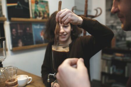 Vintage couple preparing coffee with vacuum coffee makerの写真素材