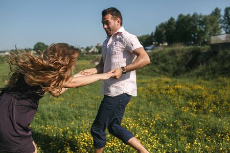 Couple running in field and have funの写真素材