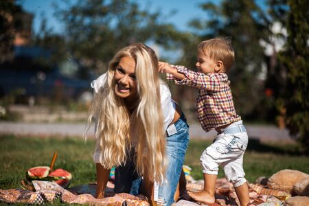 Mother with kids have fun on the grassの写真素材
