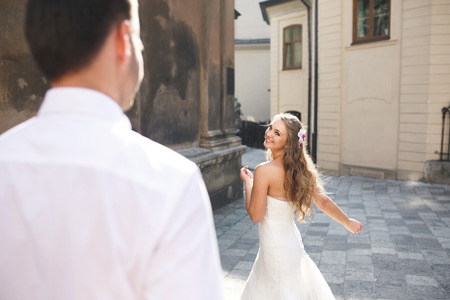 Beautiful wedding couple is walking around the cityの写真素材