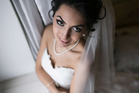 Beautiful bride posing for the camera in wedding dressの写真素材