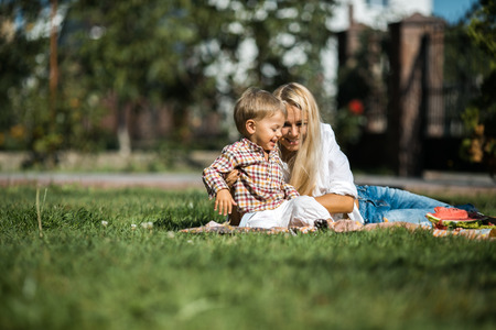 Mother with kids have fun on the grassの写真素材