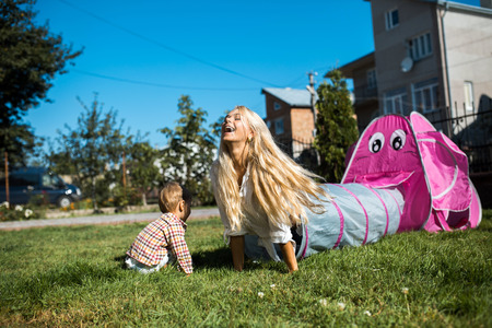 Mother with kids have fun on the grassの写真素材