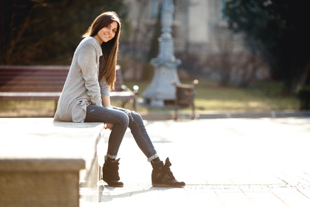 young girl posing on a background of the cityの写真素材