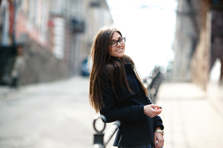 young girl posing on a background of the cityの写真素材