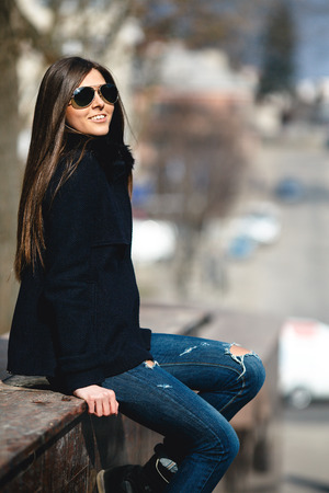 young girl posing on a background of the cityの写真素材