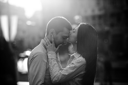 beautiful couple walking on the evening cityの写真素材