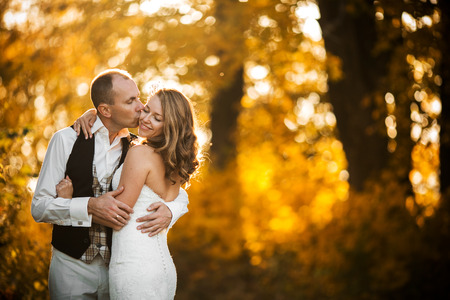 beautiful couple posing on a background autumn forestの写真素材
