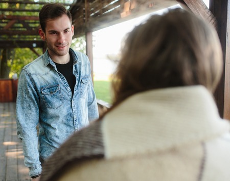 beautiful couple standing and looking one on oneの写真素材