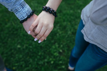 Happy couple holding hands in the sunsetの写真素材