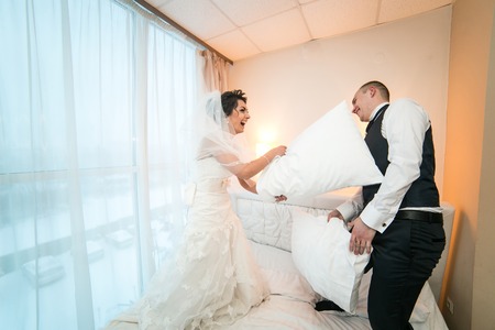 Bride and groom in a hotel roomの写真素材
