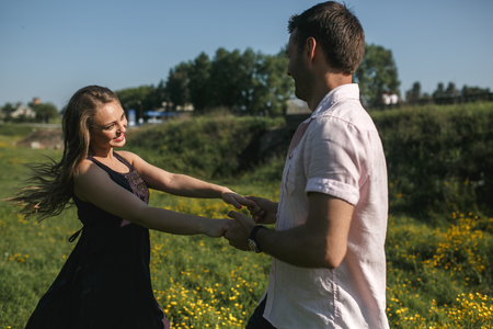 beautiful couple runs across the field and funの写真素材