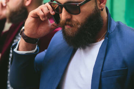 two businessmen talking on the phone in the cityの写真素材