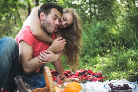 Photo of beautiful couple on nature picnicの写真素材