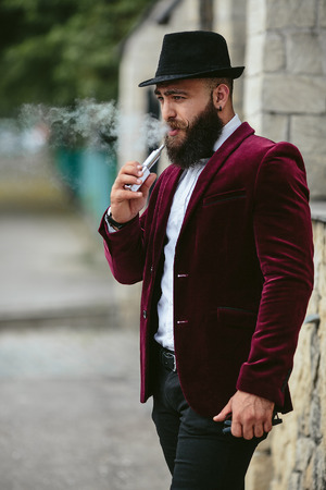 A rich man with a beard, thinking about businessの写真素材