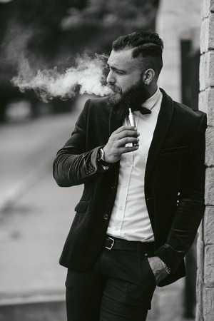A rich man with a beard, thinking about businessの写真素材