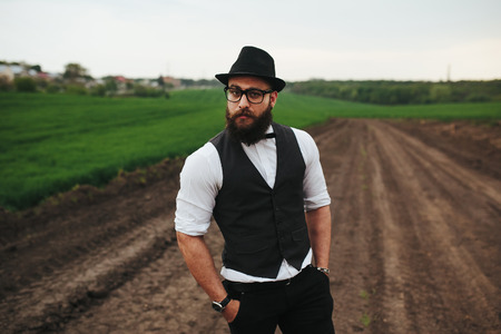 Man with a beard and sunglasses in the green fieldの写真素材