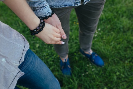 Happy couple holding hands in the sunsetの写真素材