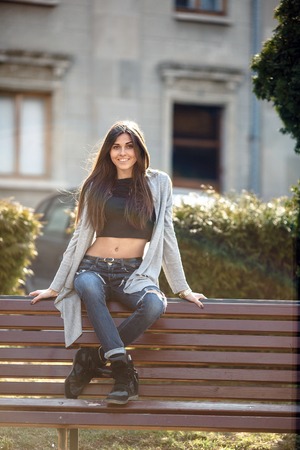 young girl posing on a background of the city