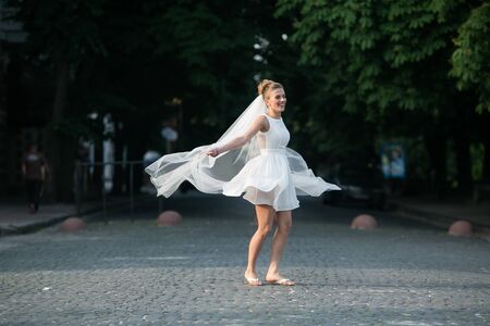 Bride jumping on the background of the cityの写真素材