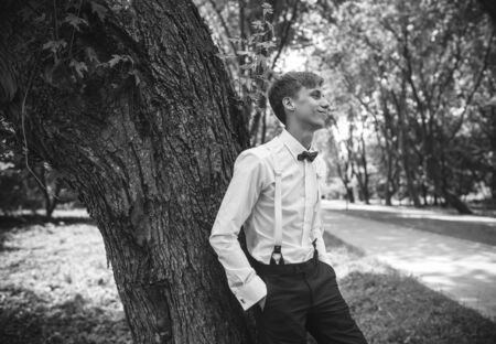 close view of the groom on a background of green parkの写真素材