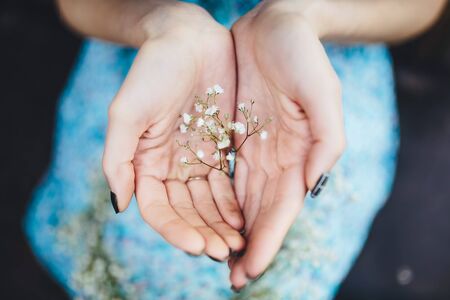 beautiful girl walks in the lush garden dressed in a wreathの写真素材