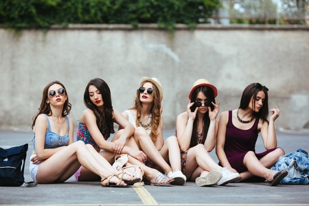 Five beautiful young girls relaxing in the cityの写真素材