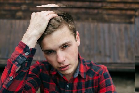 portrait photograph of a young handsome guy in a plaid shirtの写真素材