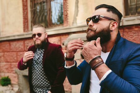 Two stylish bearded men on the background of the old town