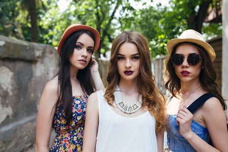 Three beautiful young girls walking in the cityの写真素材