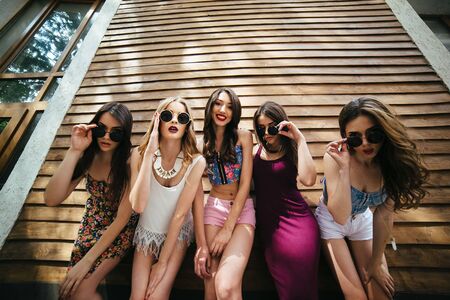 Five young beautiful girls on the street looking at the cameraの写真素材