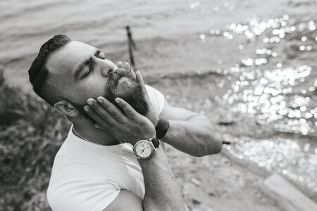 American Bearded Man looks on the river bankの写真素材