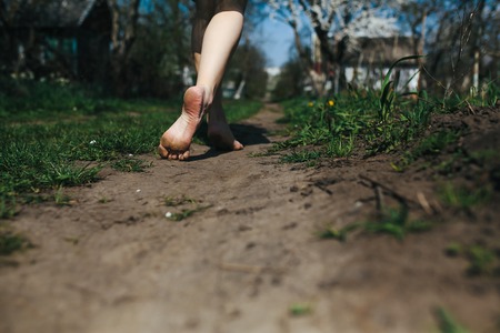 beautiful girl walks in the lush garden dressed in a wreathの写真素材