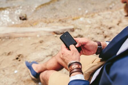 American Bearded Man looks on the river bank in a blue jacketの写真素材