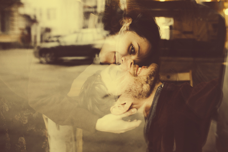 Vintage couple tenderly embracing each other and having funの写真素材