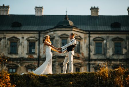 beautiful couple posing on a background of the old castleの写真素材