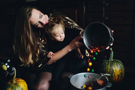 mother and daughter playing together at home on Halloweenの写真素材