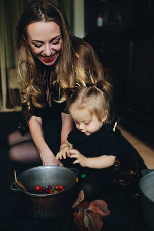 mother and daughter playing together at home on Halloweenの写真素材