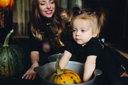 mother and daughter playing together at home on Halloweenの写真素材