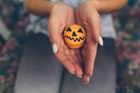 woman sitting and holding a biscuit for Halloweenの写真素材