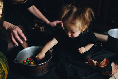 mother and daughter playing together at home on Halloweenの写真素材