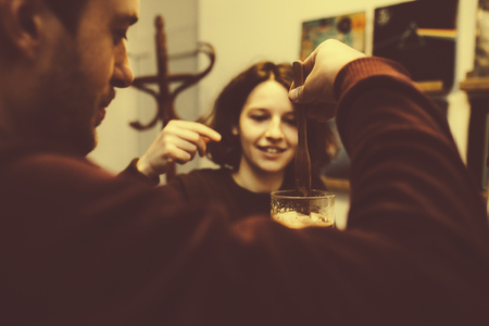 vintage couple preparing coffee with vacuum coffee makerの写真素材
