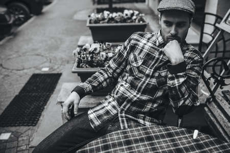 The man in the authentic boots and selvedge jeans  sitting at the tableの写真素材