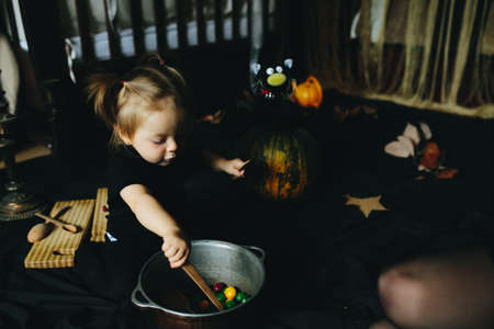 little girl playing in a witch on Halloweenの写真素材