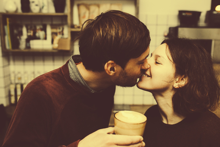 Vintage couple preparing coffee with vacuum coffee maker.Coffee shop.  Vintage tonedの写真素材