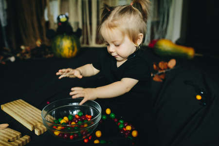 little girl playing in a witch on Halloween