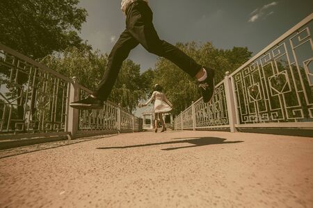beautiful couple fun on a bridge in the parkの写真素材